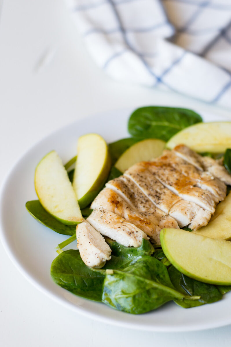 apple spinach chicken on a white plate