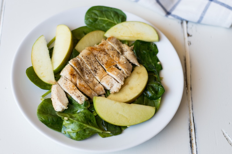 apple spinach chicken on a white plate