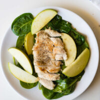 apple spinach chicken on a white plate