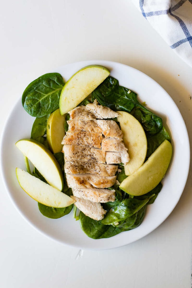 apple spinach chicken on a white plate