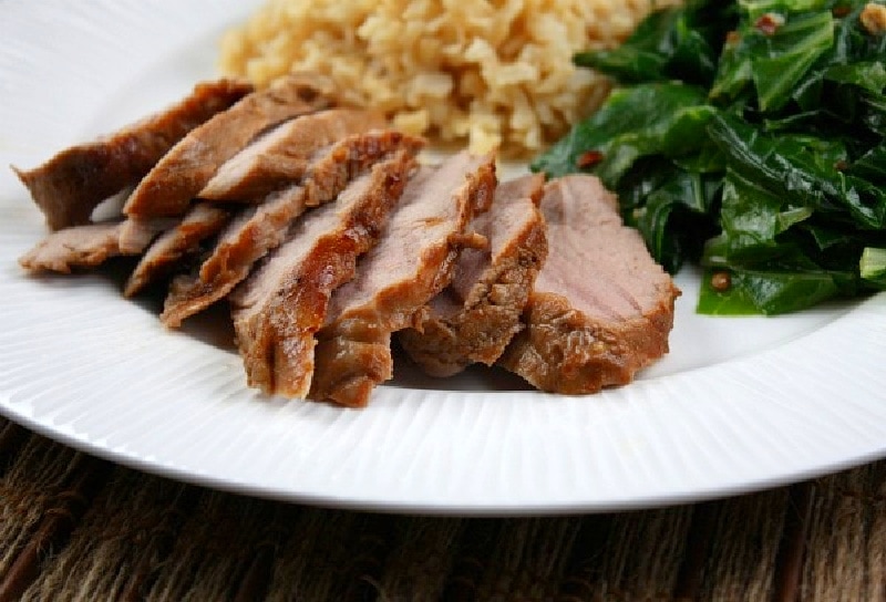 asian spiced pork tenderloin sliced on a plate