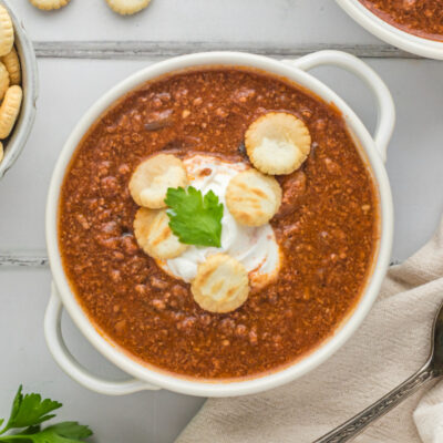 bowl of back bay chili with sour cream and crackers