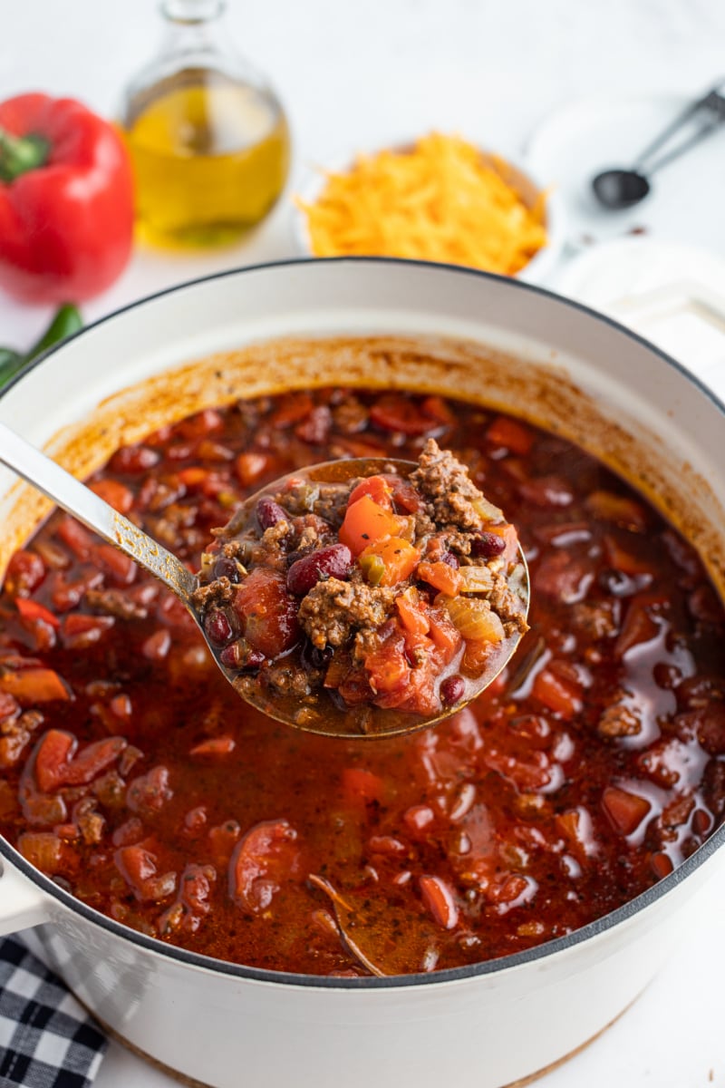 beef and bean chili being ladeled out of pot