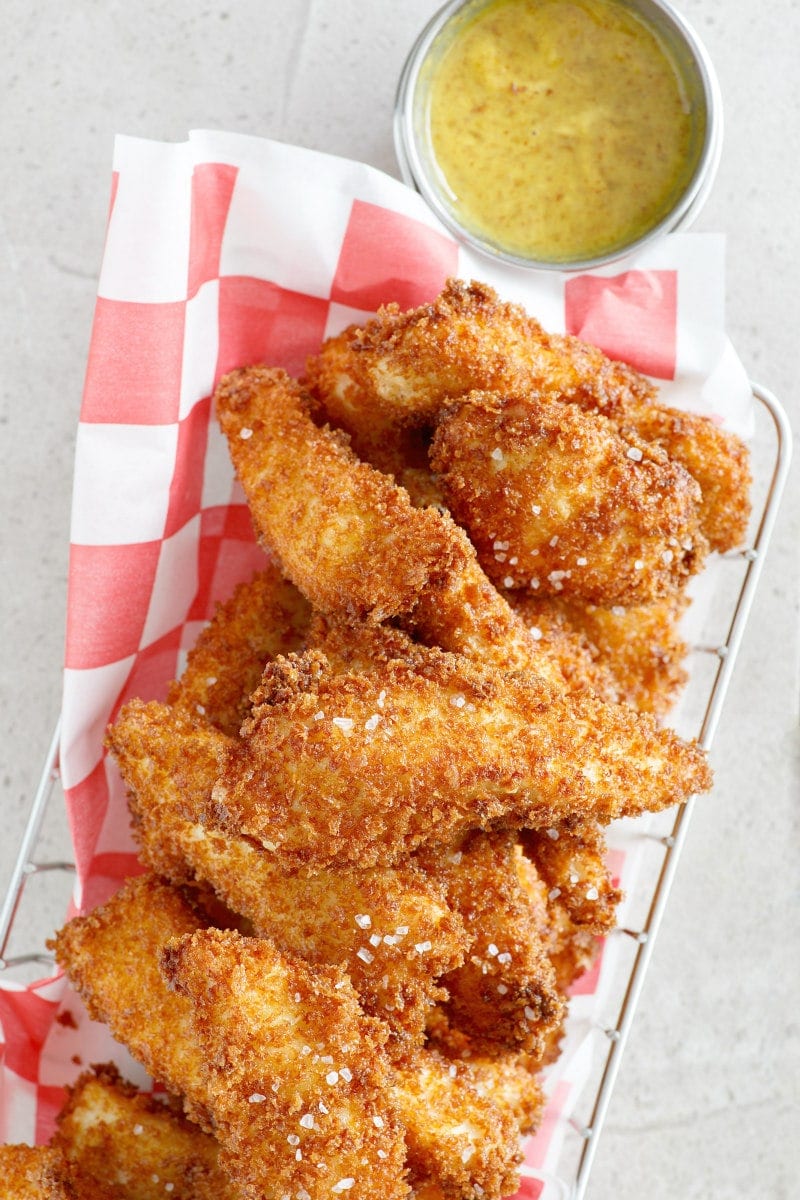 Easy Homemade Crispy Chicken Fingers with Honey Mustard Dipping Sauce recipe from RecipeGirl.com dip #sauce #recipe #RecipeGirl Crispy Chicken Fingers with Honey Mustard Dipping Sauce in a basket