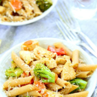 bowl of pasta with vegetables on a whit board