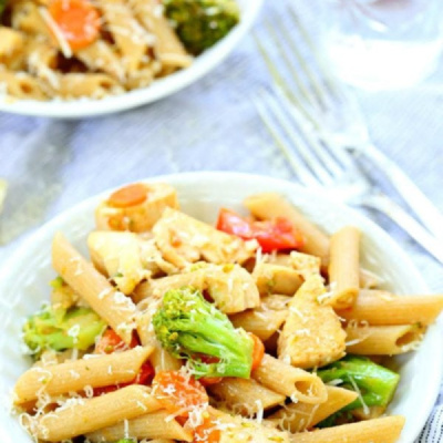 bowl of pasta with vegetables on a whit board