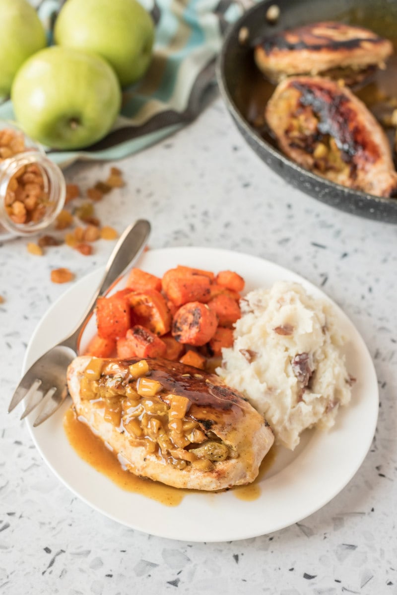 plated dinner of stuffed chicken breast with potato and carrot