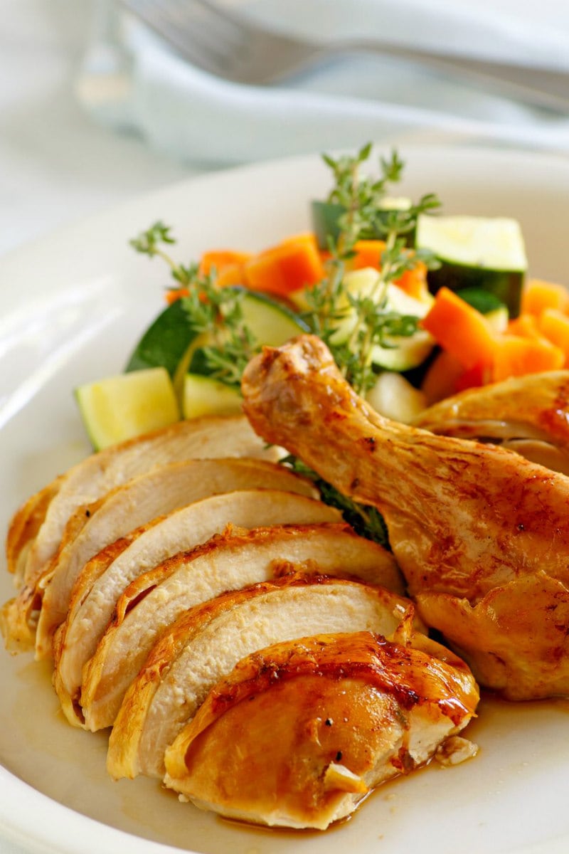 Cider Roasted Chicken recipe from RecipeGirl.com #cider #roasted #roast #chicken #fall #dinner #recipe #RecipeGirl Cider Roasted Chicken carved on a platter with vegetables