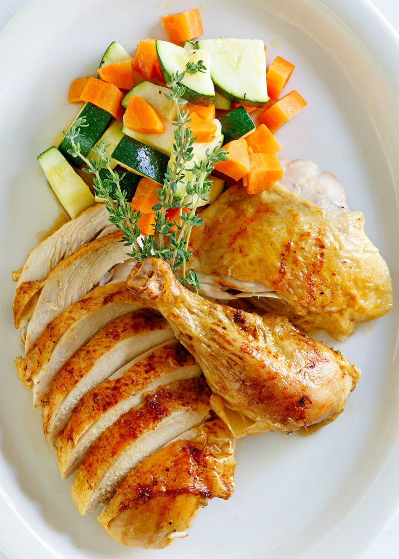 Cider Roasted Chicken recipe from RecipeGirl.com #cider #roasted #roast #chicken #fall #dinner #recipe #RecipeGirl Cider Roasted Chicken carved on a platter with vegetables