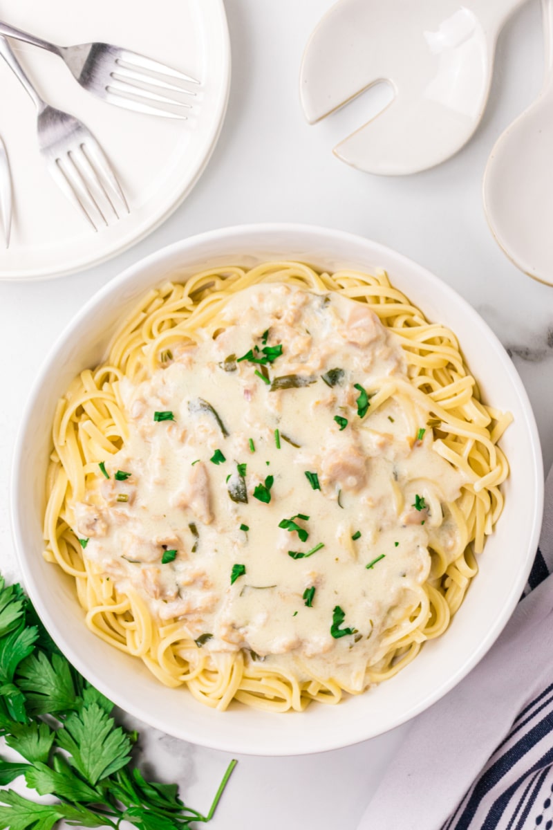 bowl of noodles with clam sauce on top