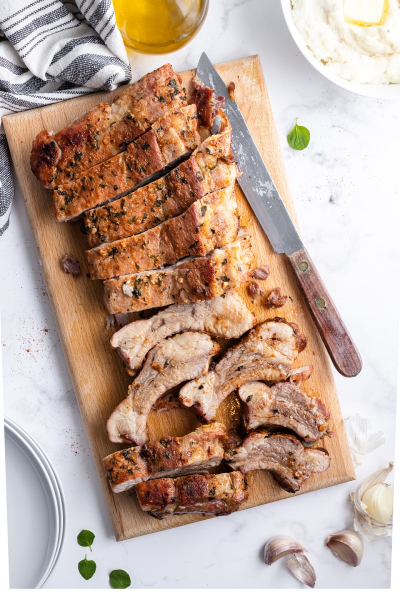 garlic and oregano pork ribs on a cutting board