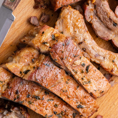 garlic and oregano pork ribs on a cutting board