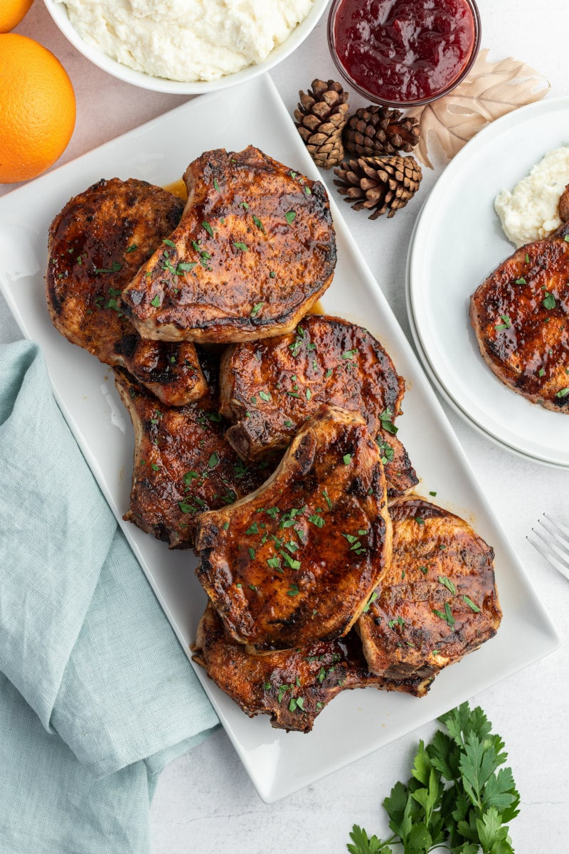 grilled pork chops on white platter