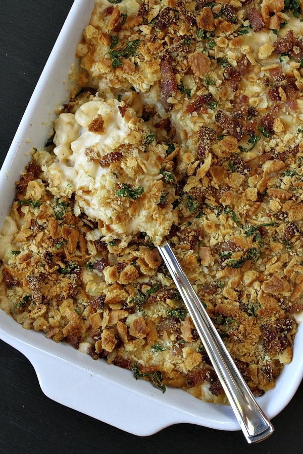 Homestyle Baked Macaroni and Cheese recipe from RecipeGirl.com #macaroni #mac #and #cheese #recipe #baked #RecipeGirl #macandcheese Spoonful of Homestyle Baked Macaroni and Cheese in a casserole dish