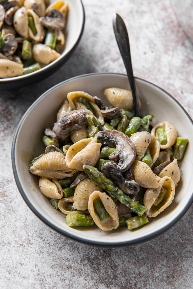 pasta shells with mushrooms and boursin sauce in white bowl