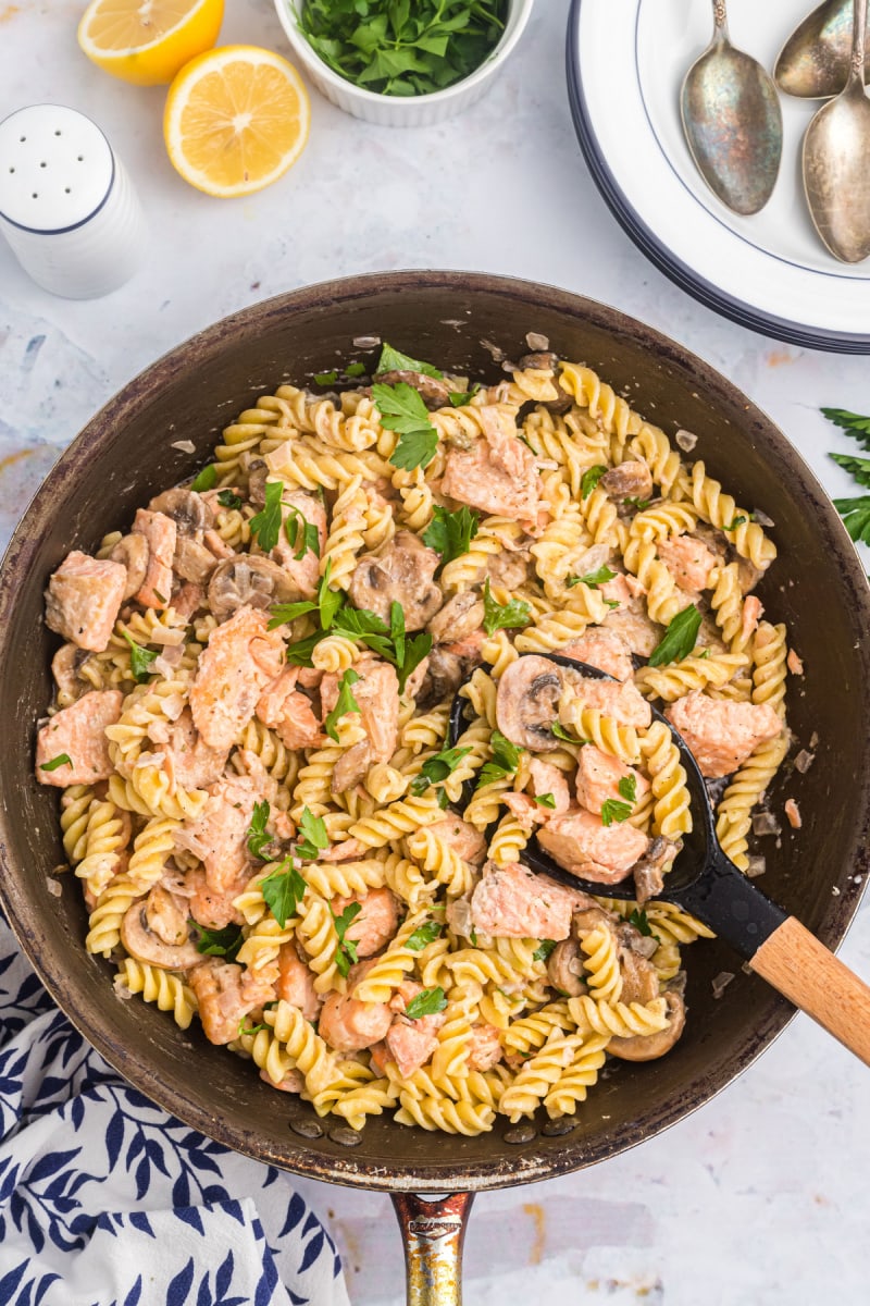 salmon fusilli in a skillet with spoon