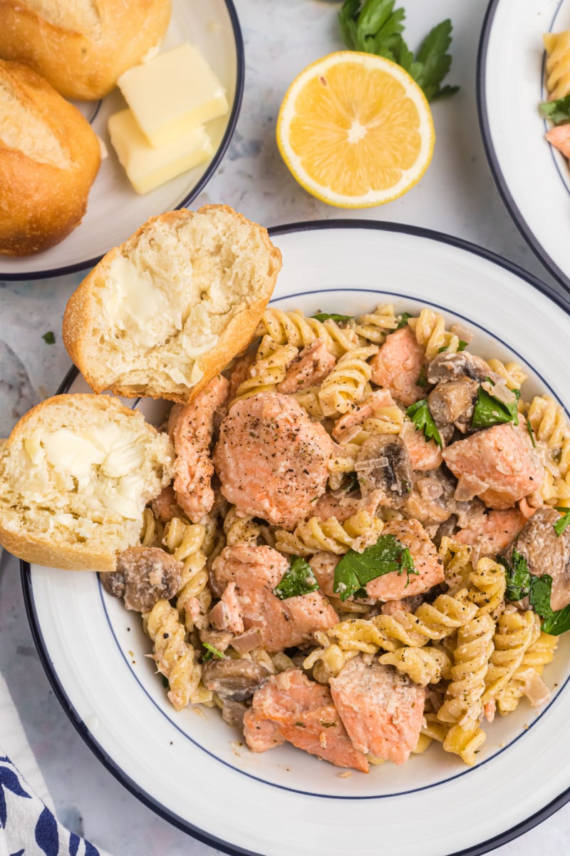 salmon fusilli with bowl with bread and butter