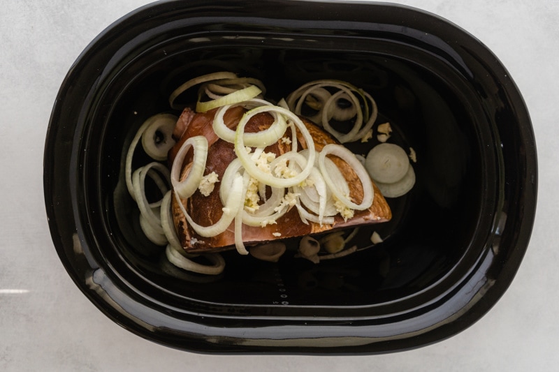 slow cooker insert with pork barbecue ingredients in it