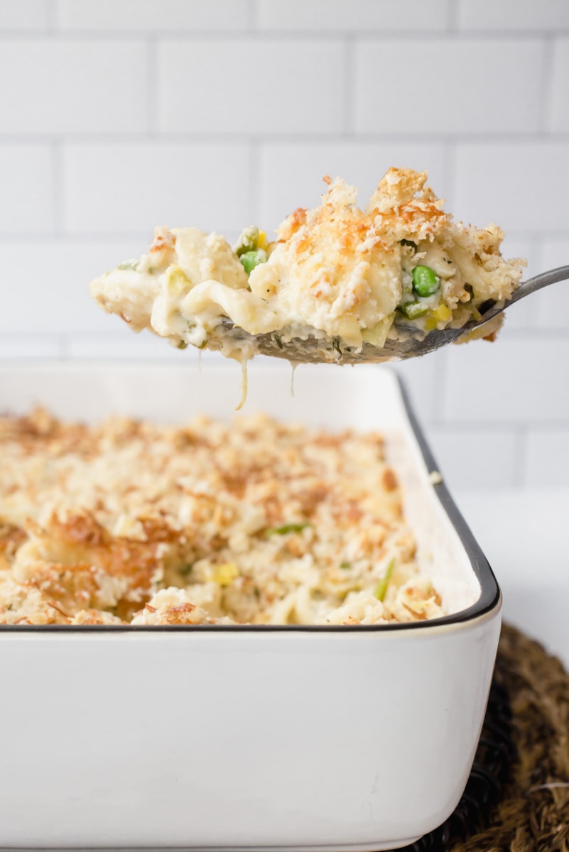 spoonful of macaroni and cheese over casserole dish
