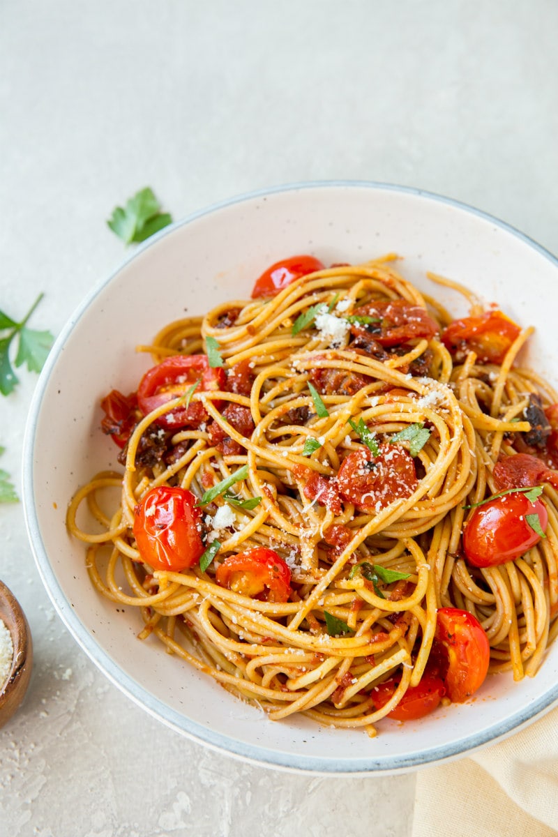 Spaghetti with Three Tomato Sauce recipe from RecipeGirl.com #spaghetti #pasta #three #tomato #sauce #sundriedtomatoes #sundried #tomatoes #cherrytomatoes #cherry #tomatoes #recipe #RecipeGirl spaghetti with three tomato sauce in a white bowl