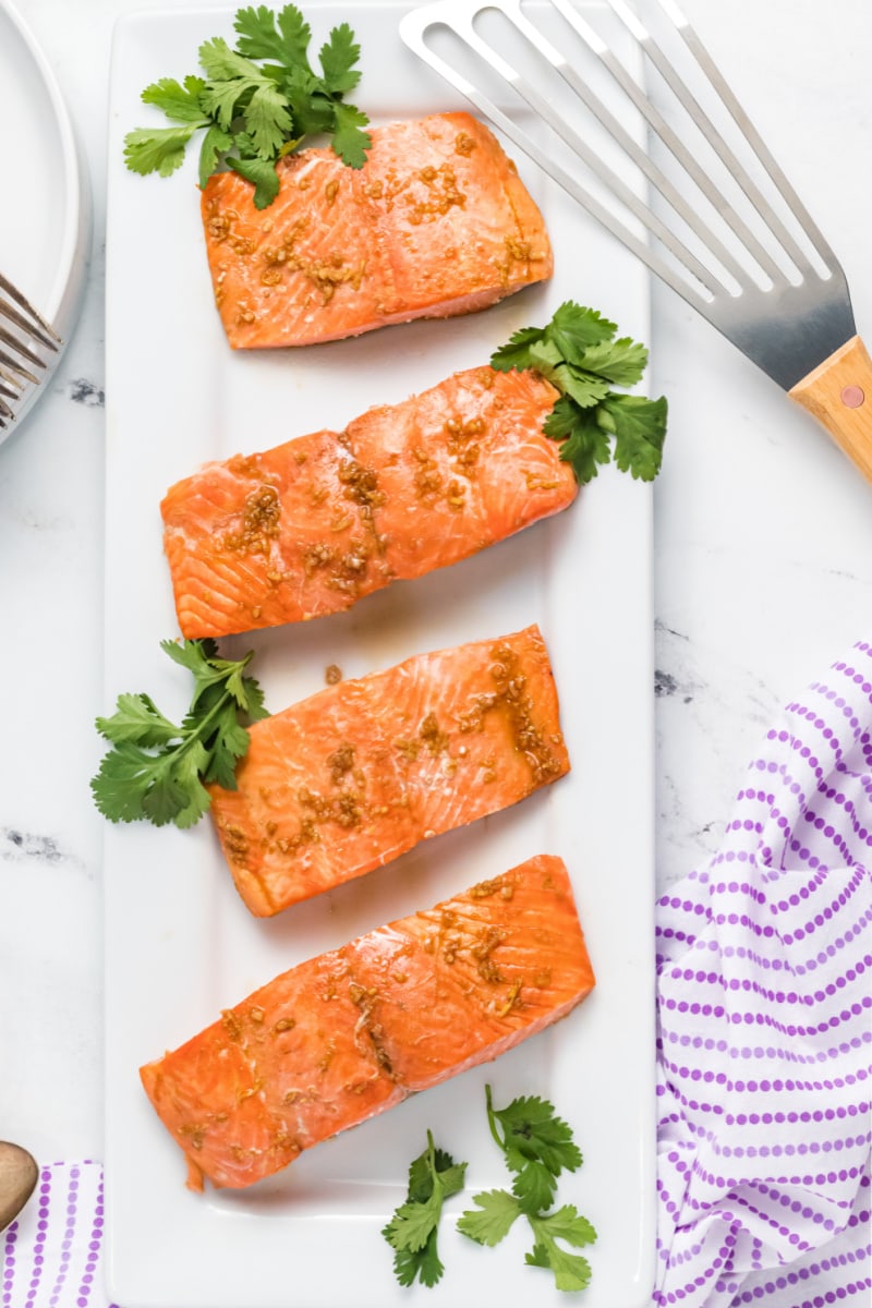 asian salmon fillets on a white platter