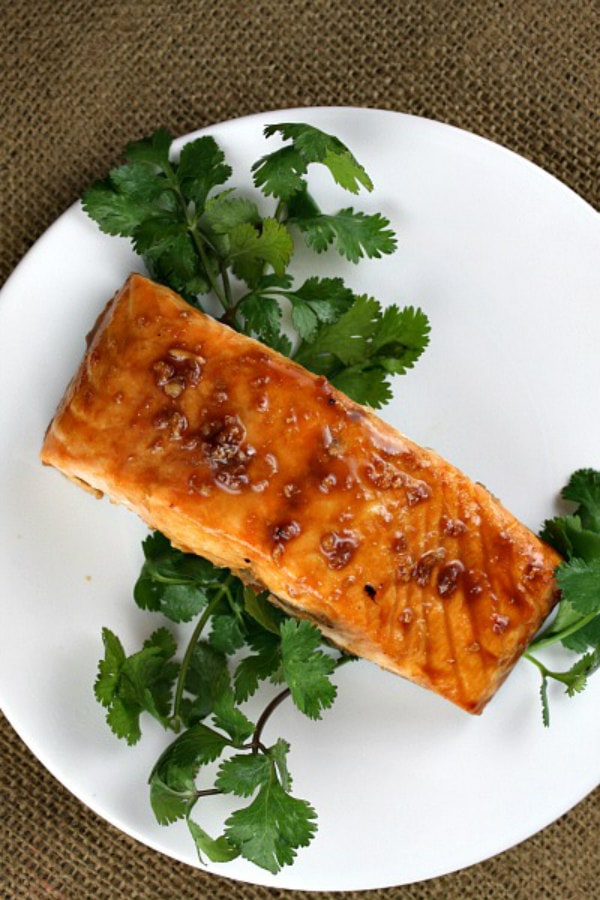 Asian Salmon Filets recipe from RecipeGirl.com #asian #salmon #filets #recipe #RecipeGirl Asian Salmon Fillet on a white plate wth cilantro