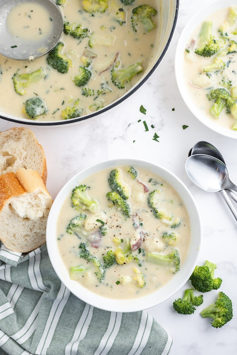 broccoli potato soup in pan and bowl