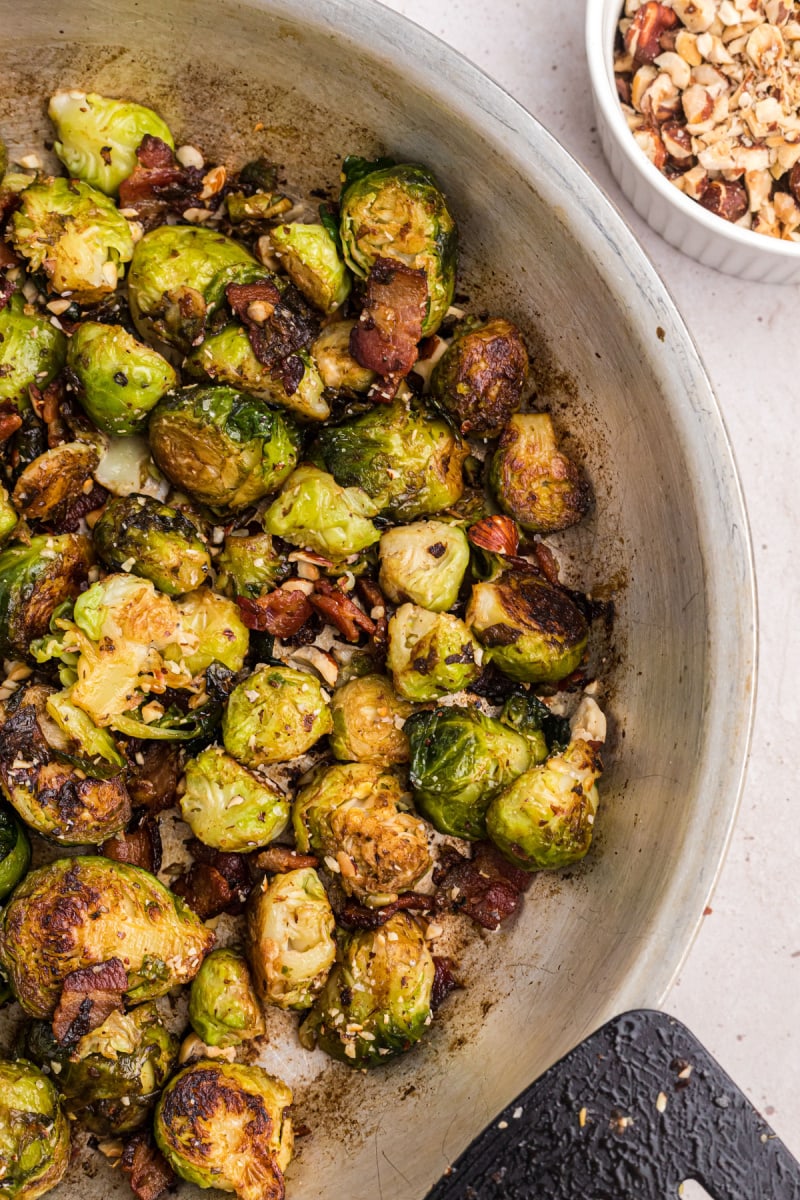 pan of brussels sprouts with bacon and hazelnuts