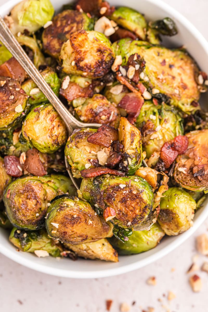 pan of brussels sprouts with bacon and hazelnuts