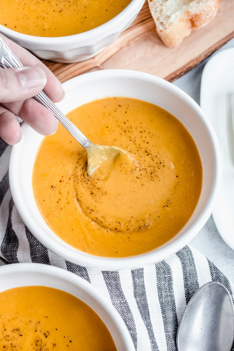 Carrot and Butternut Squash Soup recipe from RecipeGirl.com #carrot #butternut #squash #butternutsquash #soup #recipe #RecipeGirl spoonful of carrot and butternut squash soup