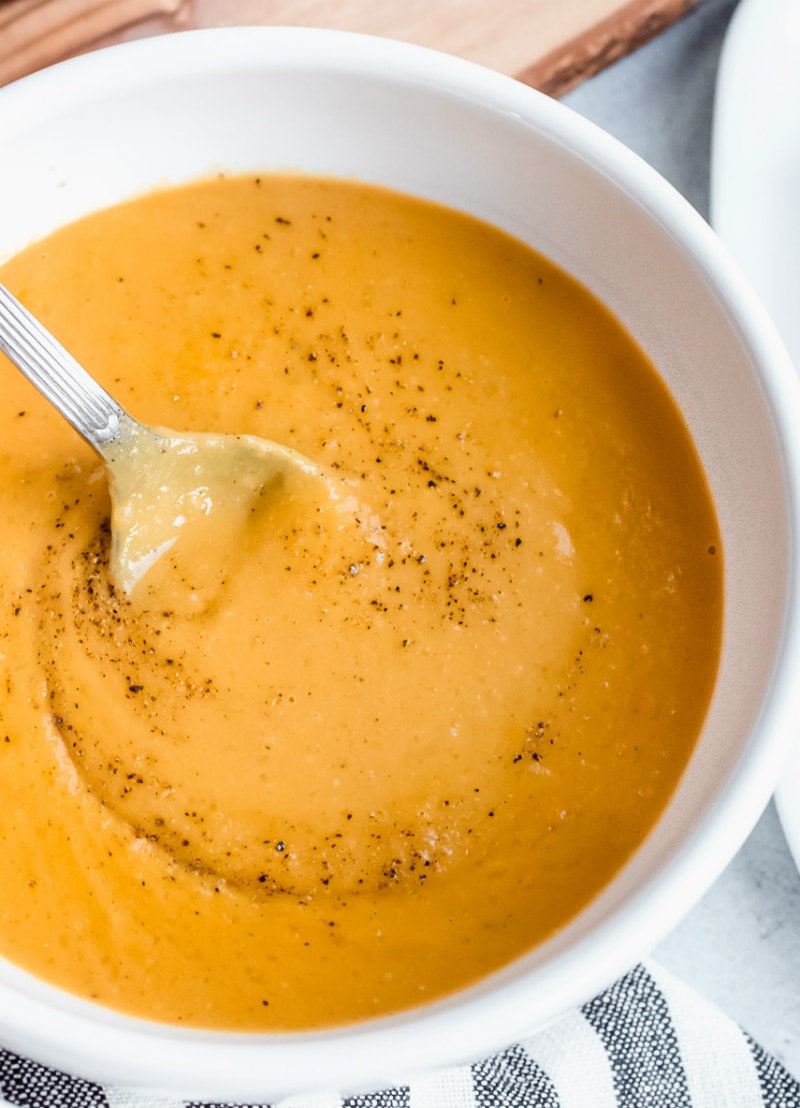 Carrot and Butternut Squash Soup recipe from RecipeGirl.com #carrot #butternut #squash #butternutsquash #soup #recipe #RecipeGirl spoonful of carrot and butternut squash soup
