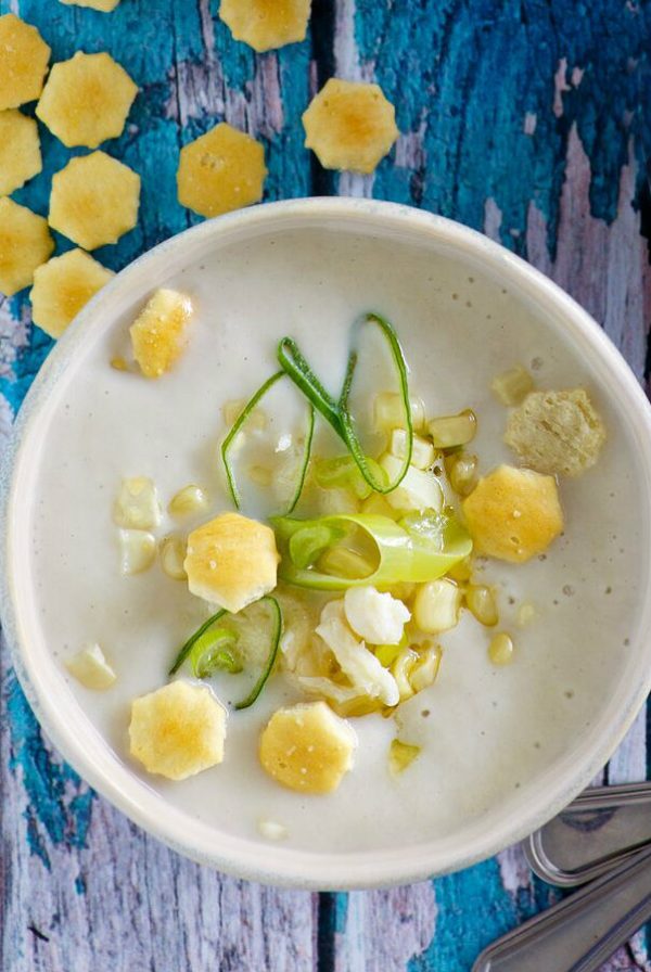 Bowl of Corn and Crab Chowder garnished with oyster crackers