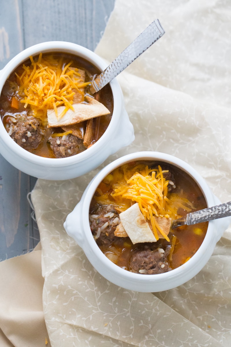 two white bowls of mexican meatball and salsa soup