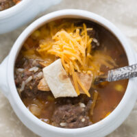 one white bowl of mexican meatball and sausage soup