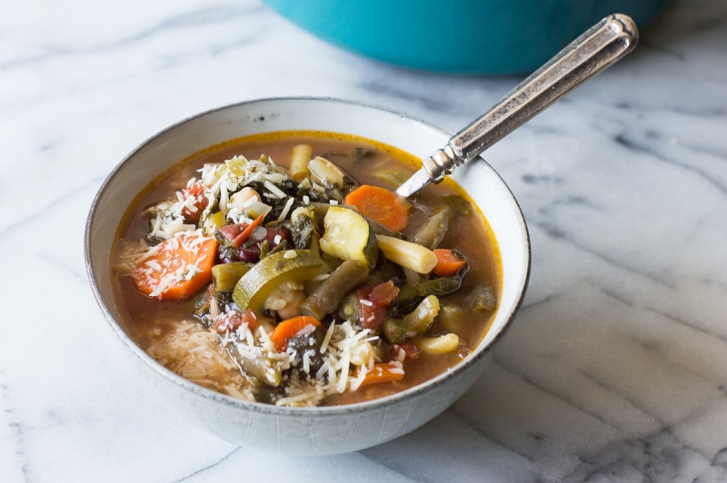Minestrone Soup recipe from RecipeGirl.com #minestrone #soup #recipe #RecipeGirl minestrone soup in a bowl with a spoon