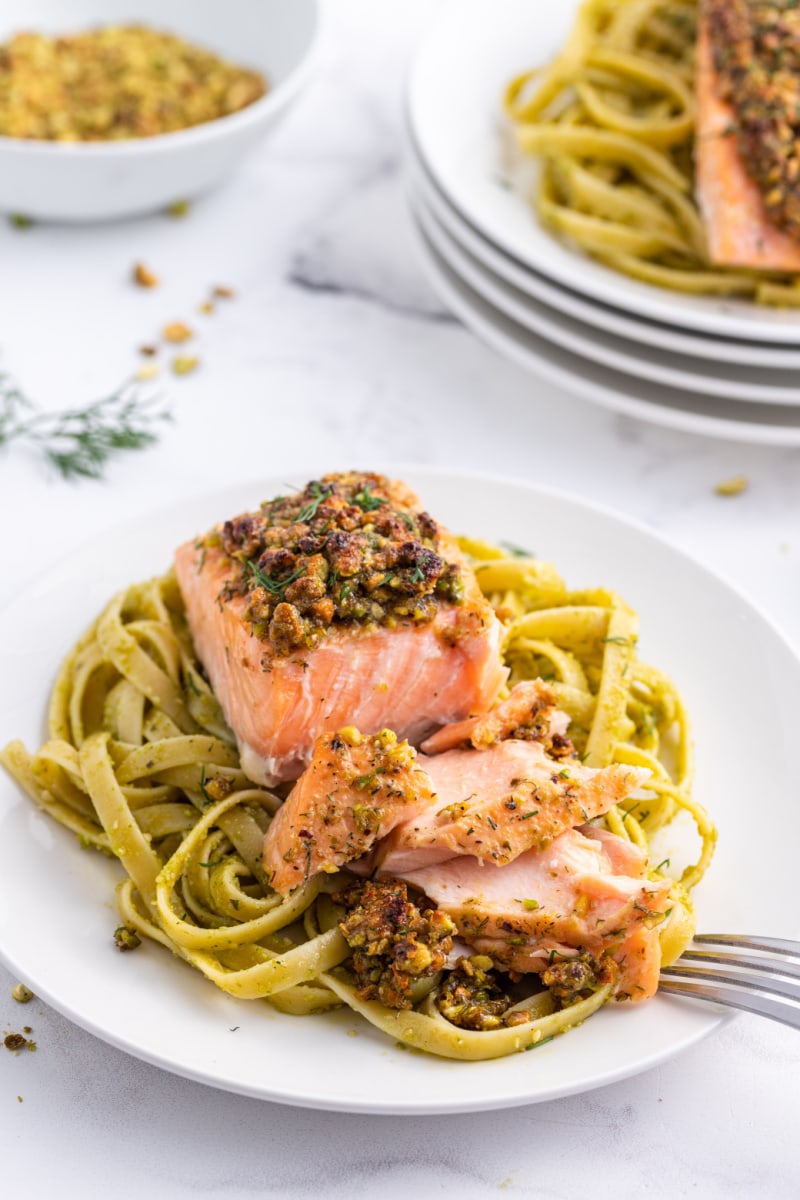 salmon filet on pasta cut open with fork