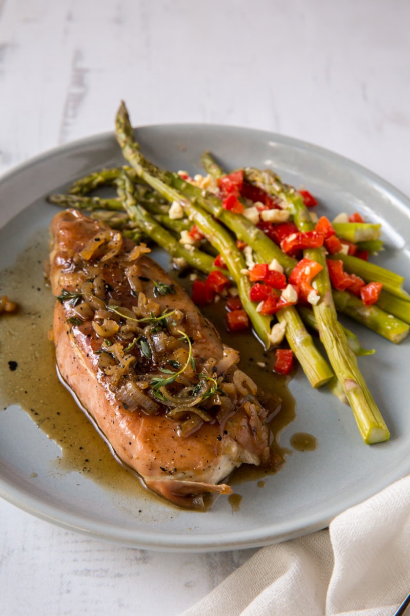 prosciutto roasted halibut on plate with asparagus