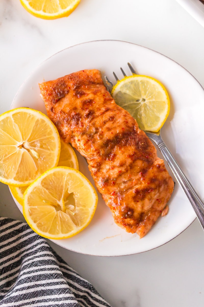 salmon fillet on plate with lemon slices