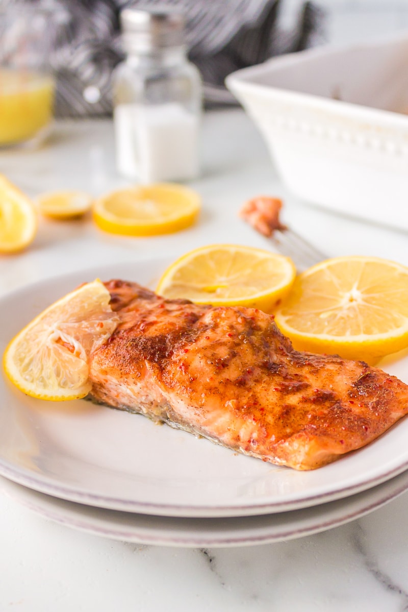 roasted salmon with pineapple marinade on plate with lemon slices