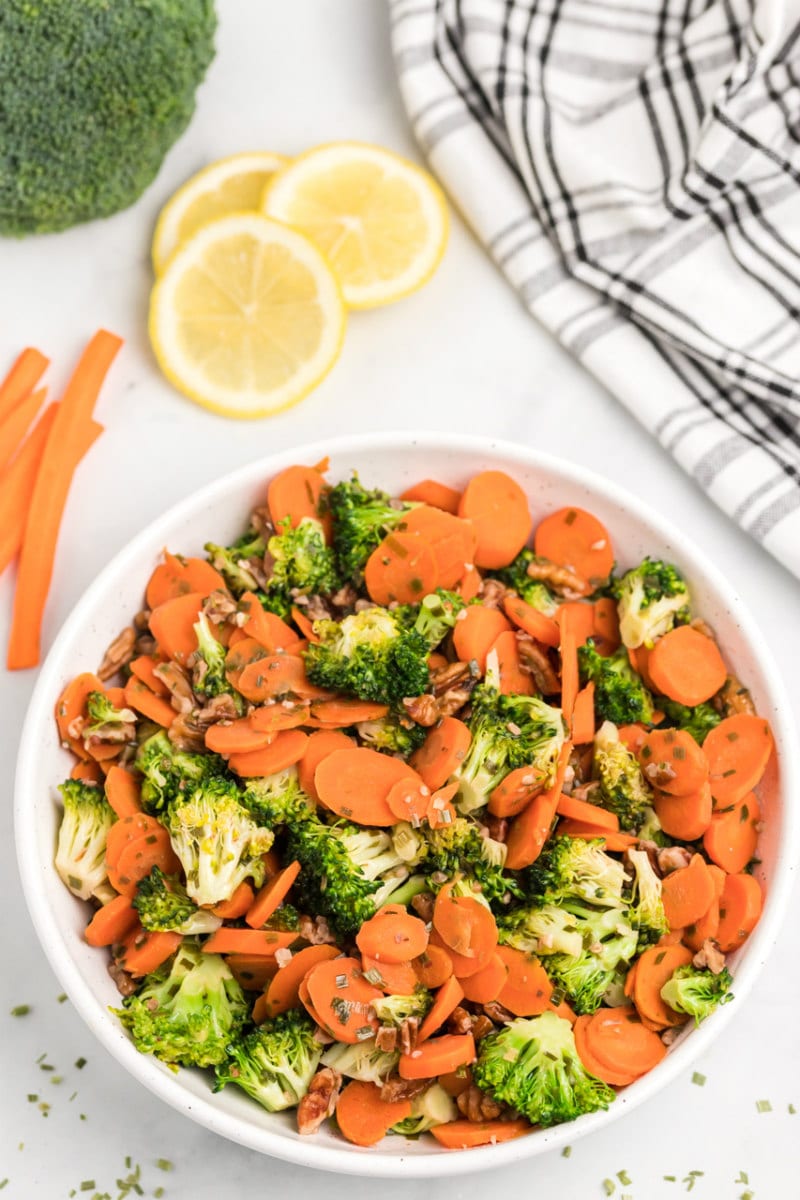 bowl of sauteed broccoli with carrots and pecans