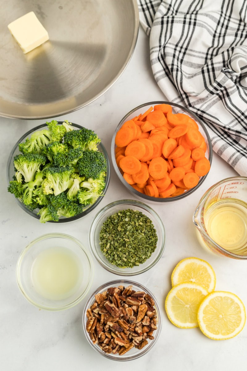 ingredients displayed for making sauteed broccoli with carrots and pecans