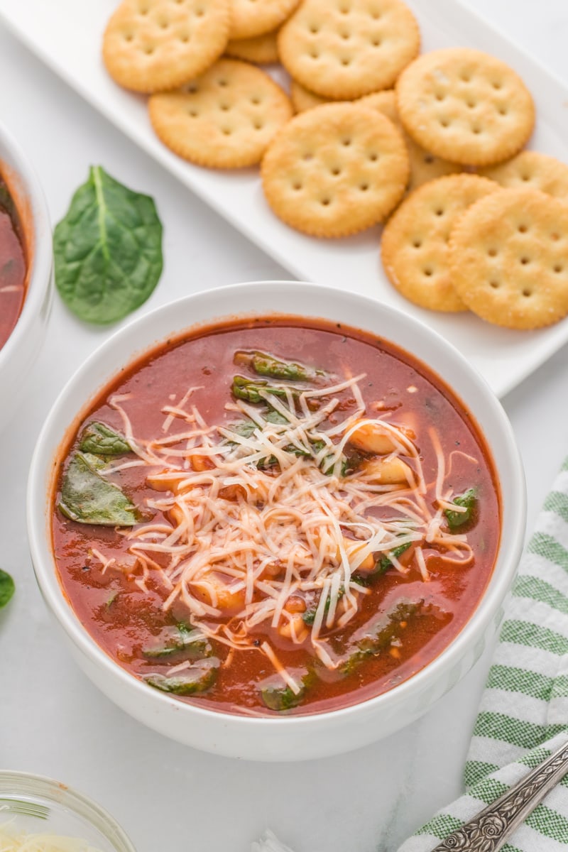 bowl of tomato florentine soup with ritz crackers on side
