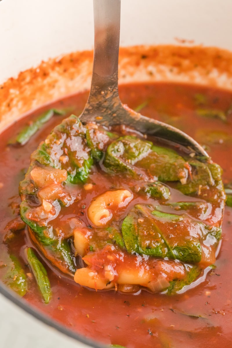 ladling out tomato florentine soup out of pot