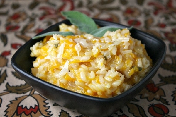 Butternut Squash Risotto in a brown dish garnished with sage