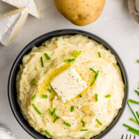 camembert mashed potatoes in a bowl with a pat of butter