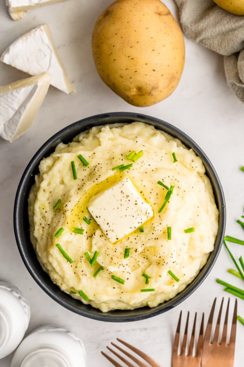 camembert mashed potatoes in a bowl with a pat of butter