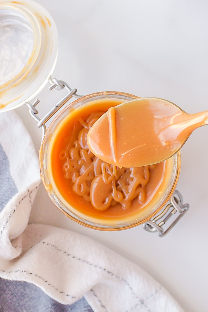 spoon with jar of caramel