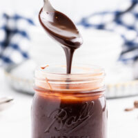 spooning fudge sauce out of jar