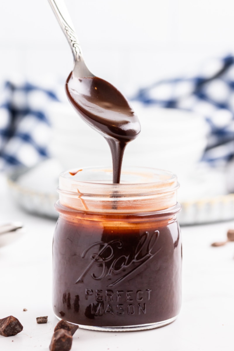 spooning fudge sauce out of jar