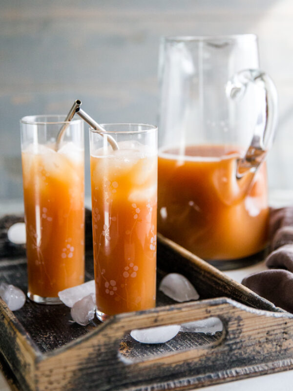 pitcher of easy punch recipe with two glasses of punch
